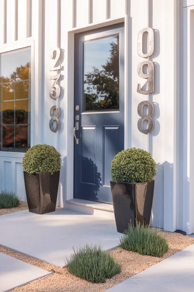 Front entry details for low maintenance front yard landscaping with planters and house numbers