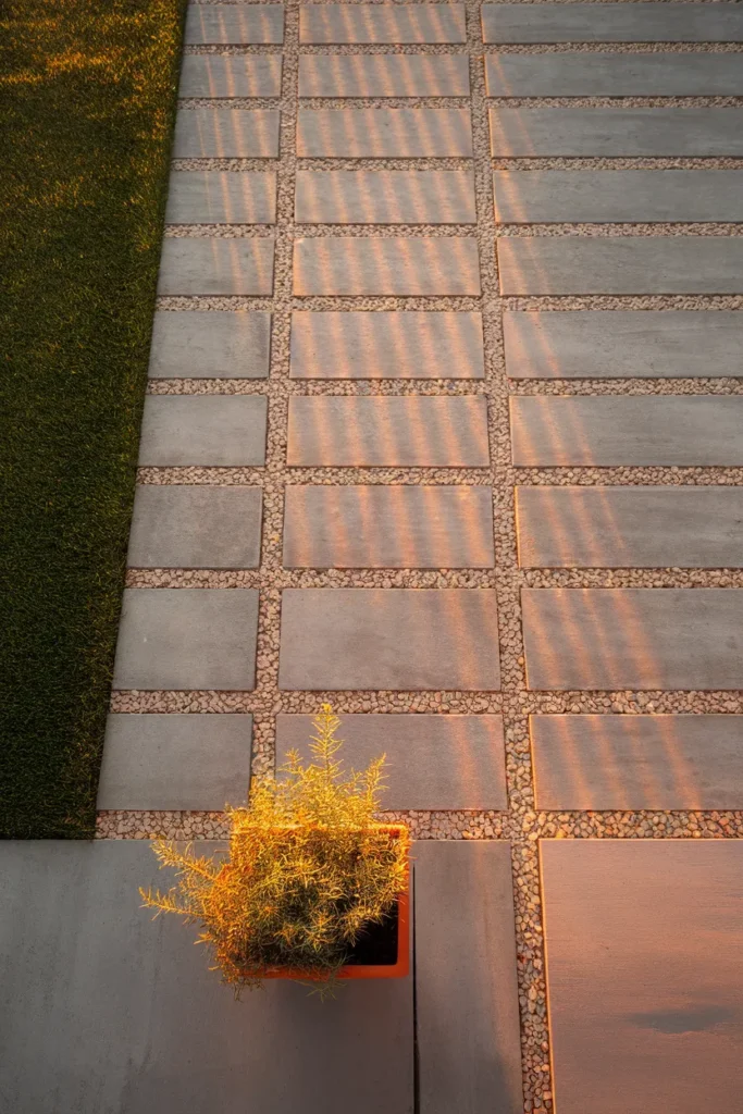 Inexpensive patio ideas overhead view of a DIY paver and gravel grid floor