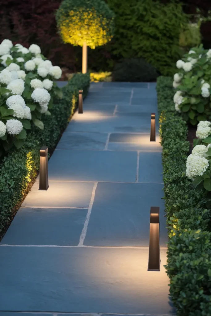 Path lighting for small front yard landscaping ideas with staggered low voltage fixtures