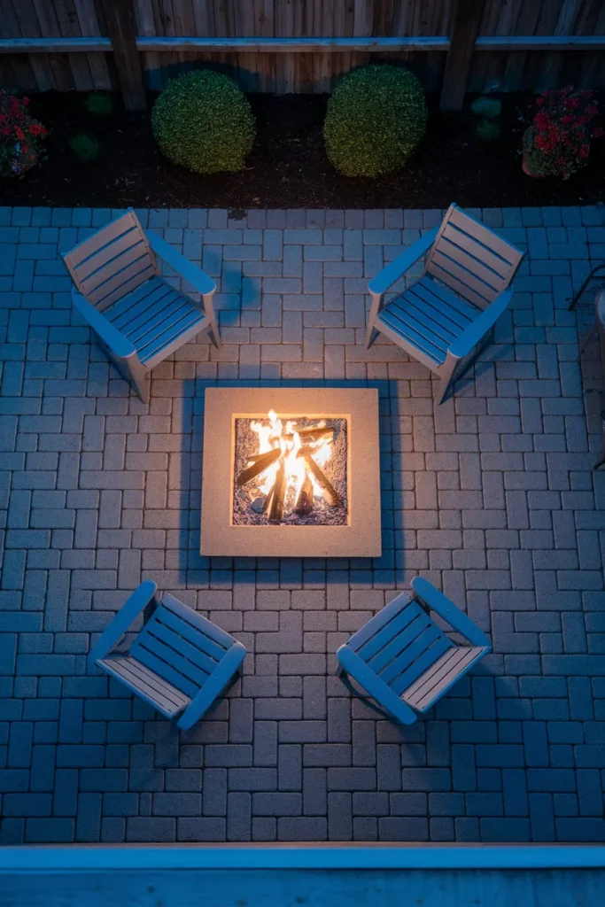 Propane fire pit on paver patio seen from above with seating and clearance
