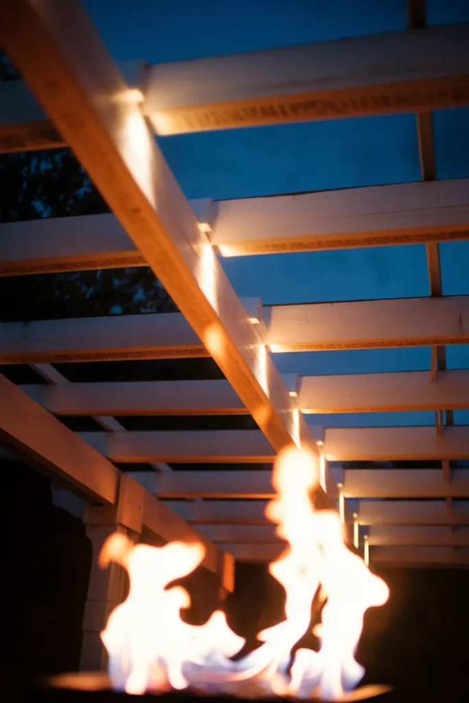 Soot shadowing on pergola beams above a fire pit showing why clearance height matters