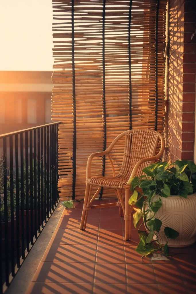 Balcony covering ideas with rolled bamboo railing screen and warm golden hour light