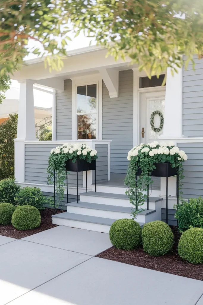 Matching planter boxes flanking porch steps for raised flower bed curb appeal