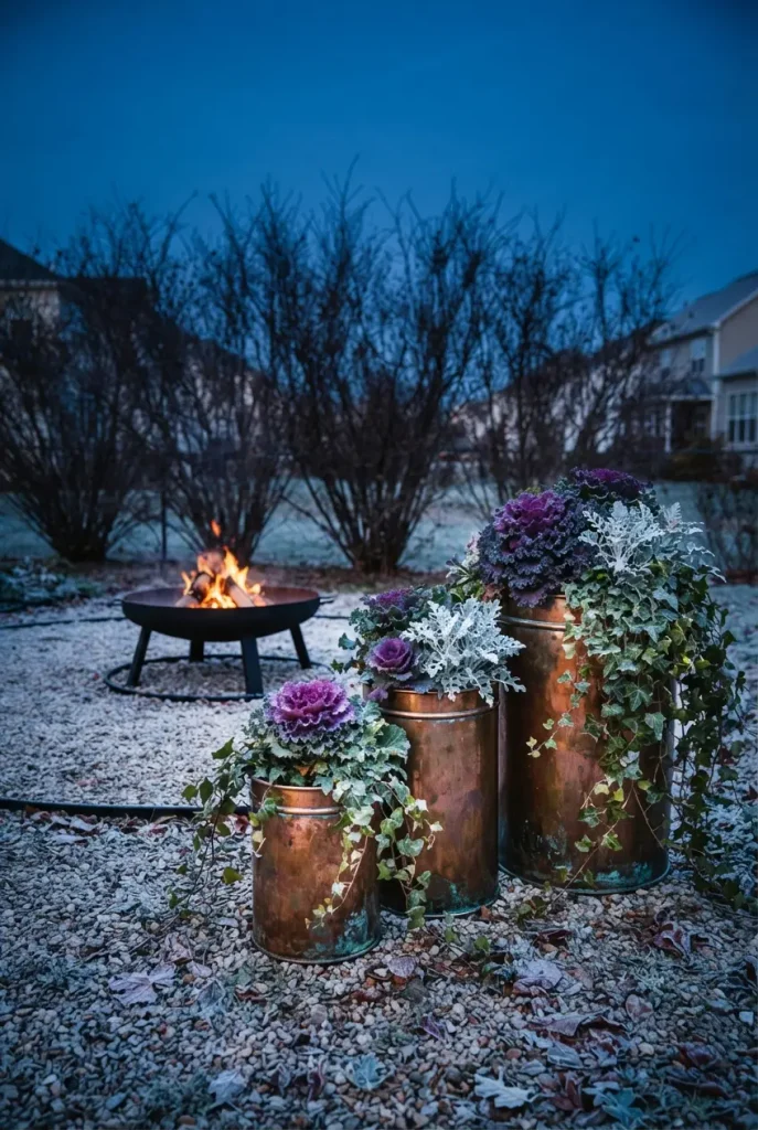 Cottage garden fire pit with copper pots of ornamental kale in late fall