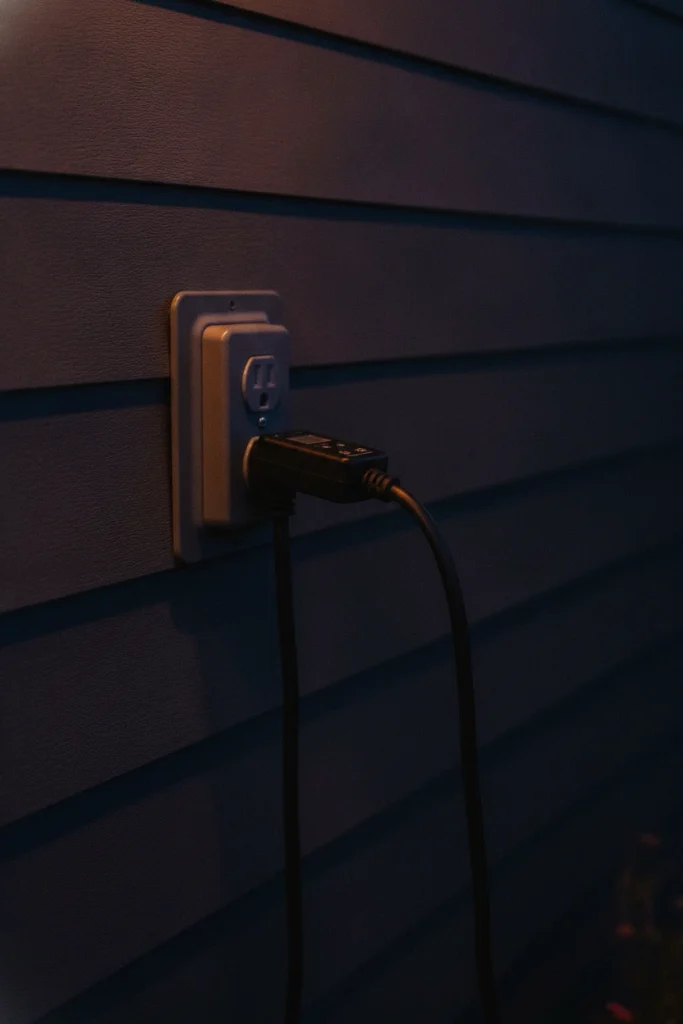 Outdoor lighting makeover power setup with an outdoor cord and timer at a weatherproof outlet