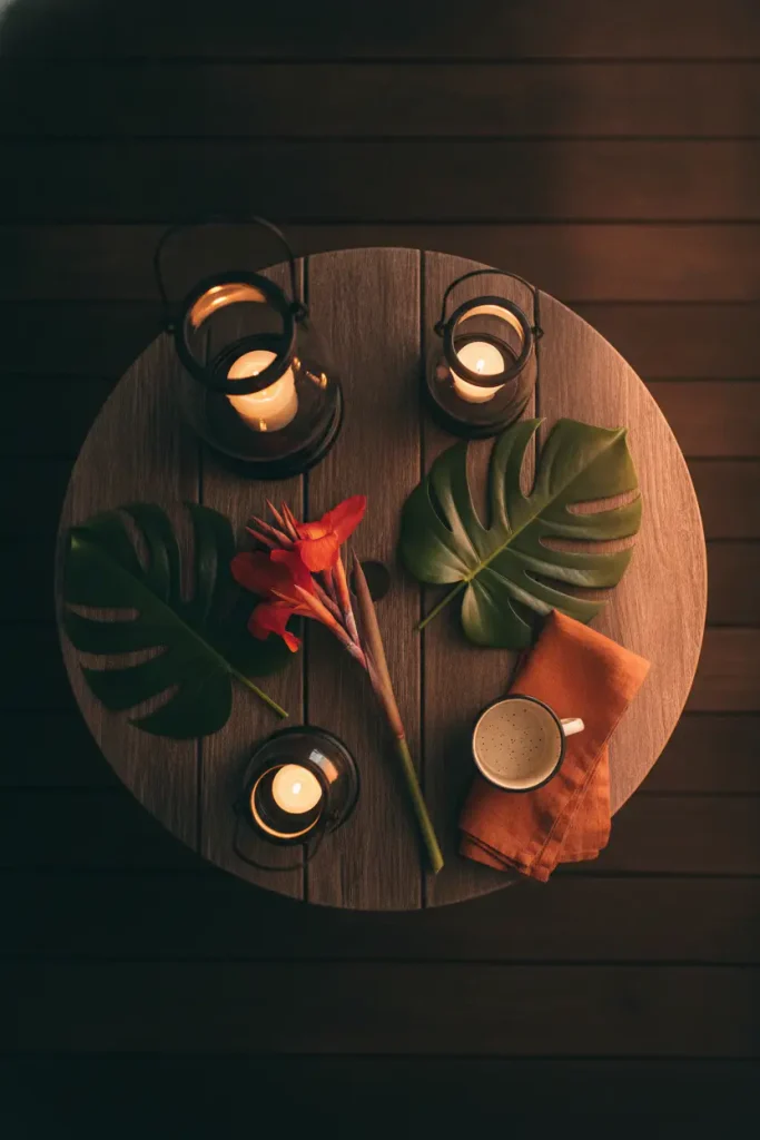 Tropical cozy backyard ideas using lanterns at three heights on a fall patio table
