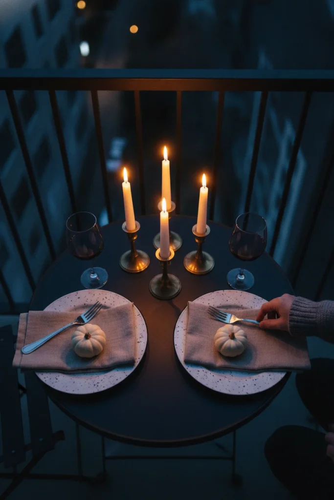all dinner for two on a balcony lit by LED taper candles in brass holders