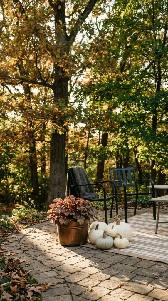 Fall shade decor ideas: a pale striped outdoor rug brightening a shady paver patio
